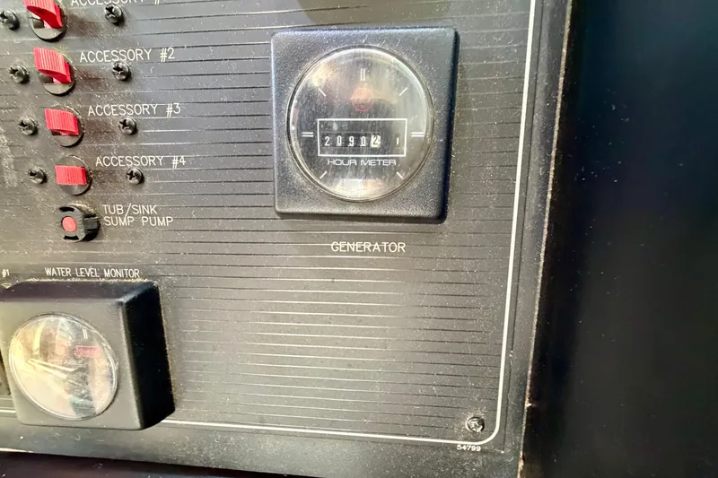 Slide: The Image of Control panel of 1995 Bayliner 4788 Pilot House Motoryacht with hour meter and switches. - 29