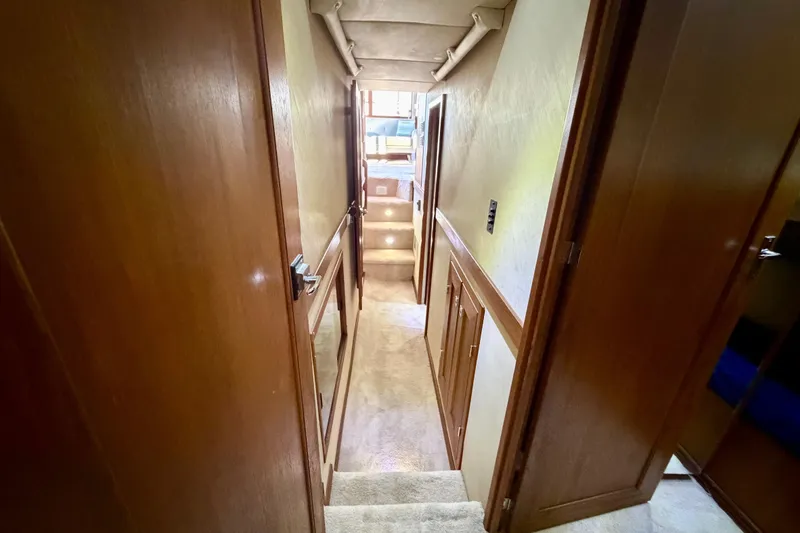 Slide: The Image of Interior hallway of 1995 Bayliner 4788 Pilot House Motoryacht with wooden doors and carpeted floor. - 42