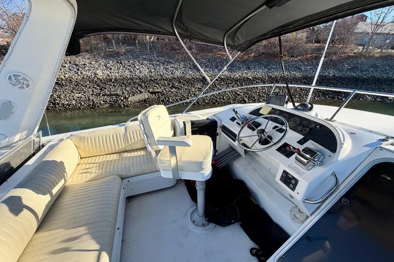 Slide: The Image of 1995 Bayliner 4788 Pilot House Motoryacht cockpit with steering wheel and seating area. - 44