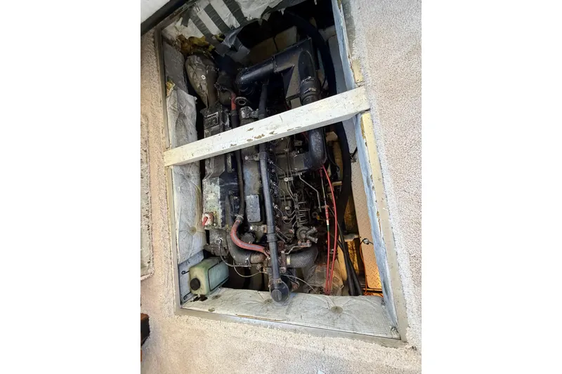 Slide: The Image of Engine compartment of a 1995 Bayliner 4788 Pilot House Motoryacht, showing mechanical components. - 48
