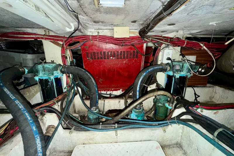 Slide: The Image of Engine room of a 1995 Bayliner 4788 Pilot House Motoryacht, showing hoses and wiring. - 51