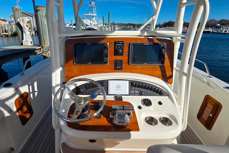 Slide: The Image of 2013 Boston Whaler 320 Outrage helm with dual displays and steering wheel. - 16