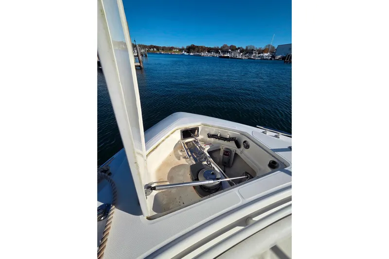 Slide: The Image of 2013 Boston Whaler 320 Outrage bow with anchor system, docked in a marina. - 23