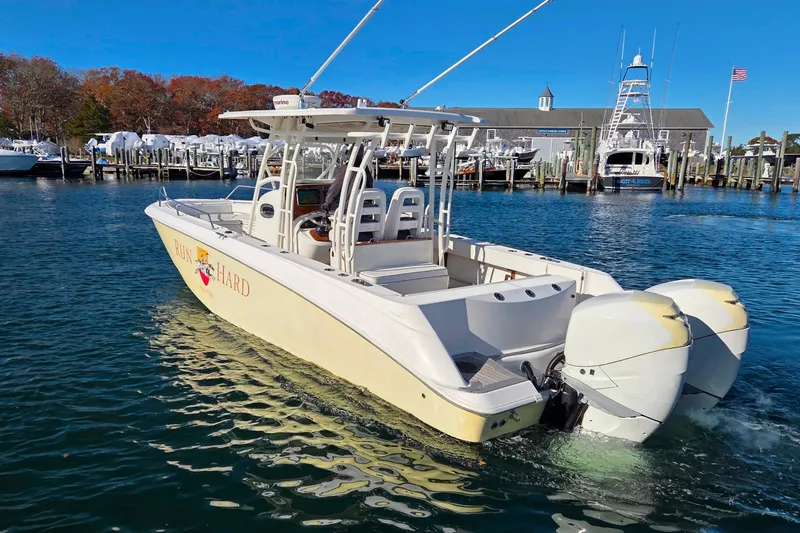 Slide: The Image of 2013 Boston Whaler 320 Outrage boat docked in a marina with twin engines. - 6