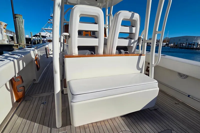Slide: The Image of 2013 Boston Whaler 320 Outrage boat interior with seating and deck view. - 21