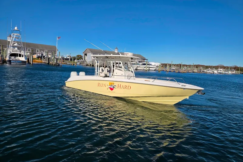 Slide: The Image of 2013 Boston Whaler 320 Outrage boat docked in a marina under clear blue skies. - 5