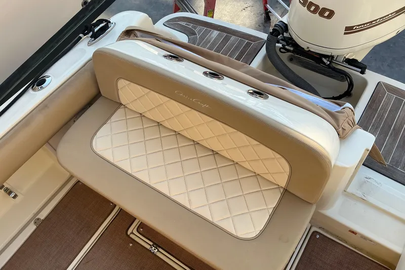 Slide: The Image of 2016 Chris-Craft Catalina 23 boat interior with cushioned seating and outboard motor. - 10