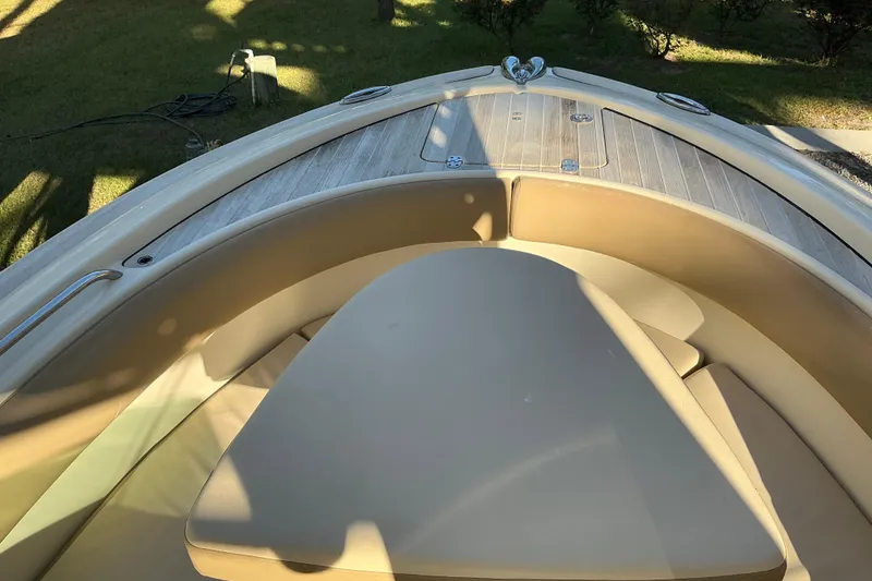 Slide: The Image of 2016 Chris-Craft Catalina 23 boat interior with cushioned seating and wooden deck. - 12