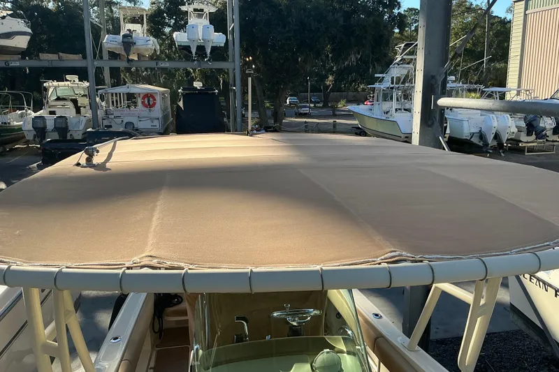 Slide: The Image of 2016 Chris-Craft Catalina 23 boat with a beige canopy in a marina setting. - 15