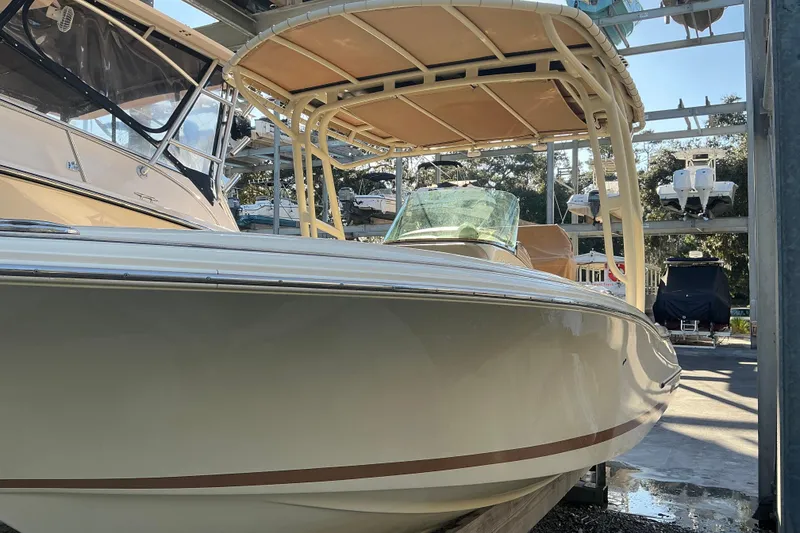 Slide: The Image of 2016 Chris-Craft Catalina 23 boat in storage, showcasing sleek design and canopy. - 20