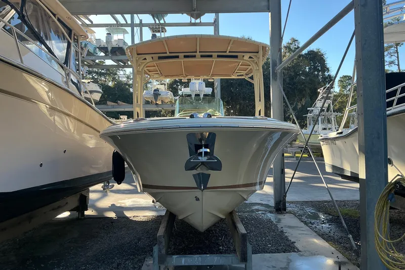Slide: The Image of 2016 Chris-Craft Catalina 23 boat in storage, front view, surrounded by other boats. - 21