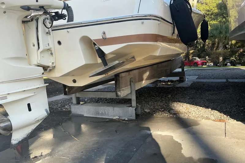 Slide: The Image of 2016 Chris-Craft Catalina 23 boat on a lift, showing hull and outboard motor. - 26