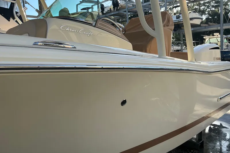 Slide: The Image of 2016 Chris-Craft Catalina 23 boat, sleek design with chrome accents, docked outdoors. - 28