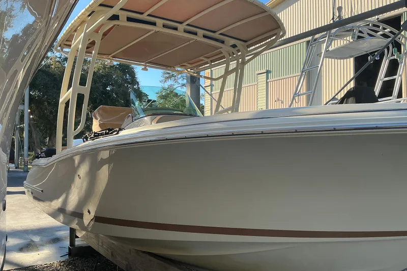 Slide: The Image of 2016 Chris-Craft Catalina 23 boat with canopy, docked outdoors. - 4