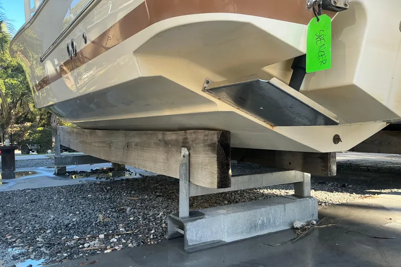 Slide: The Image of 2016 Chris-Craft Catalina 23 boat on wooden supports, outdoor setting. - 7