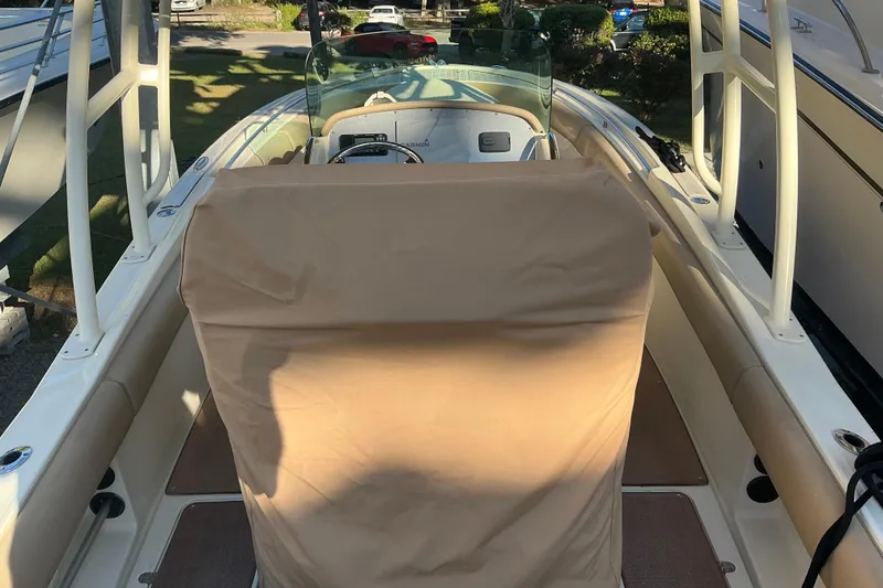 Slide: The Image of 2016 Chris-Craft Catalina 23 boat interior with covered seating and steering wheel. - 8