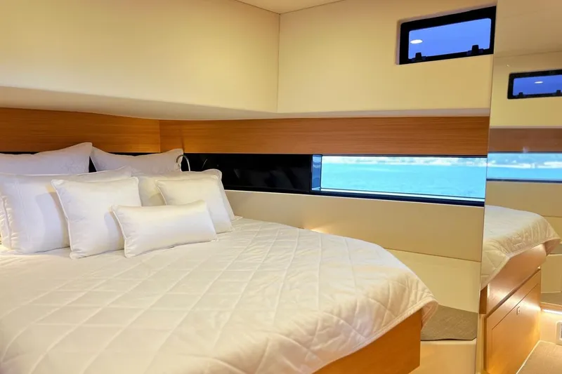Slide: The Image of Luxurious bedroom interior of 2023 De Antonio Yachts D42 Open, featuring elegant bedding and ocean view. - 17