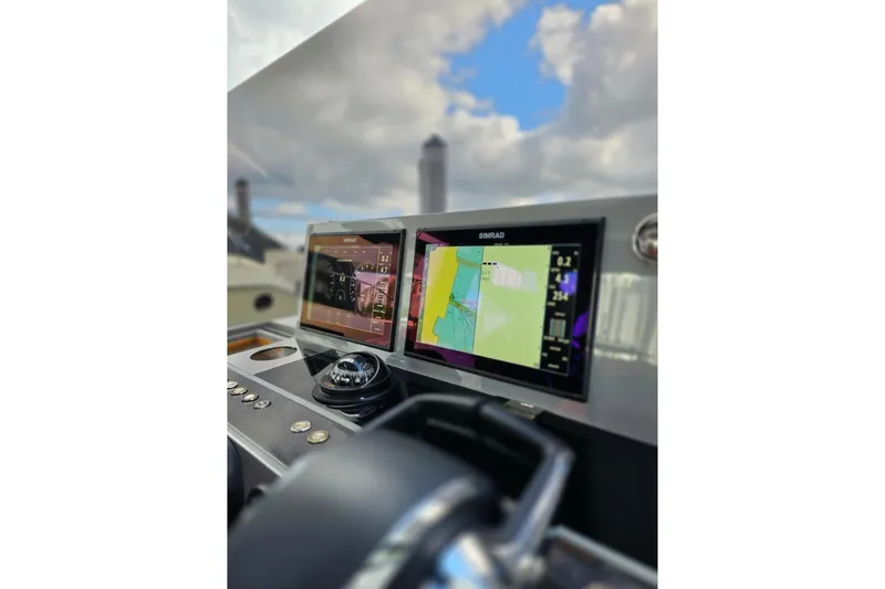 Slide: The Image of 2023 De Antonio Yachts D42 Open dashboard with navigation screens and controls. - 6