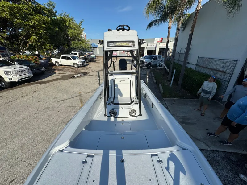 Slide: The Image of 2025 Yellowfin 24 CE boat in a parking lot, surrounded by trees and vehicles. - 13