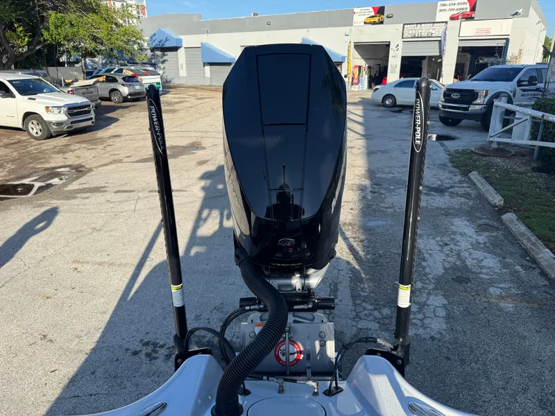 Slide: The Image of 2025 Yellowfin 24 CE boat engine with Power-Pole anchors in a parking lot. - 19