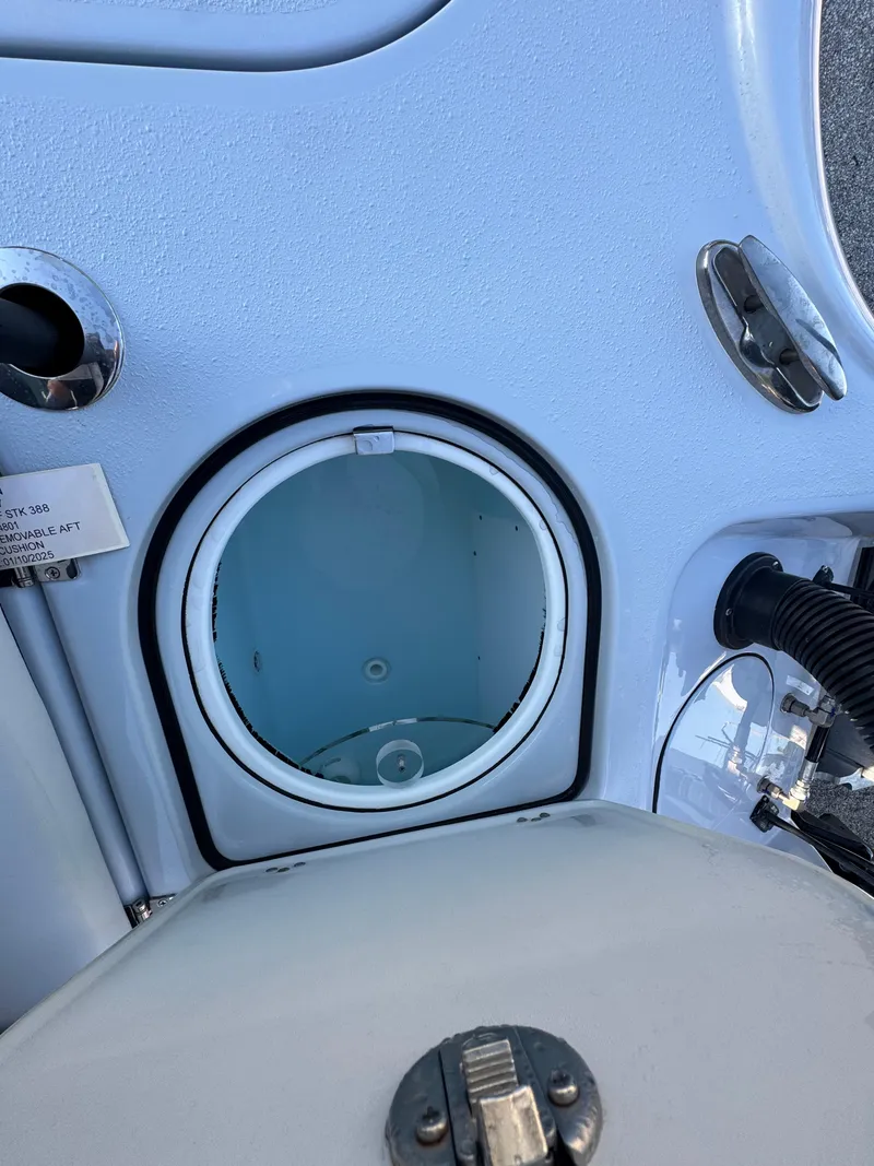Slide: The Image of 2025 Yellowfin 24 CE boat compartment with open hatch and visible interior. - 21