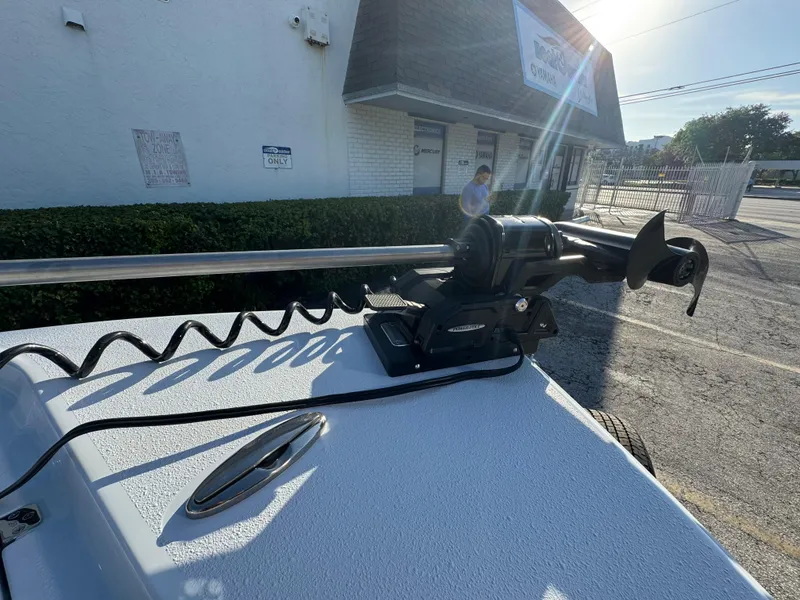 Slide: The Image of 2025 Yellowfin 24 CE boat with mounted trolling motor in a sunny outdoor setting. - 27