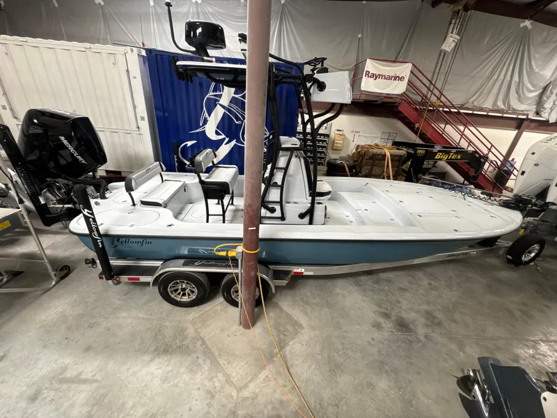 Slide: The Image of 2025 Yellowfin 24 CE boat in a garage, featuring a sleek design and dual engines. - 3