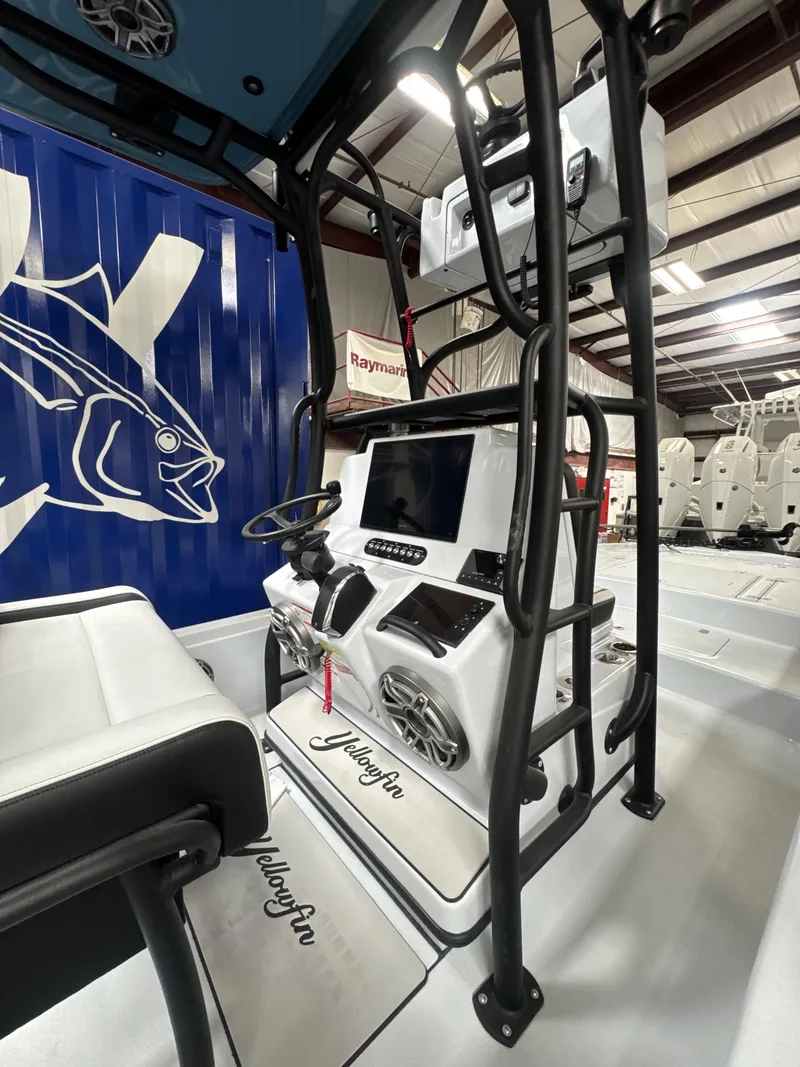 Slide: The Image of 2025 Yellowfin 24 CE boat interior with advanced navigation system and sleek design. - 4