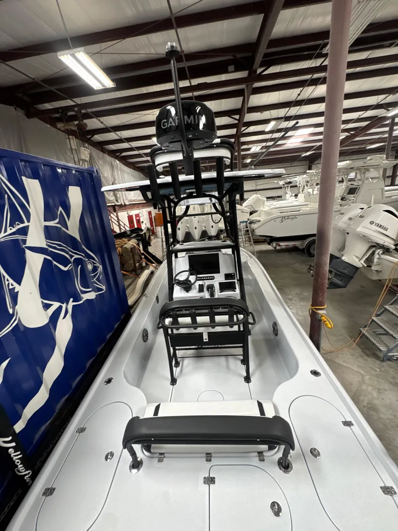 Slide: The Image of 2025 Yellowfin 24 CE boat in a warehouse, featuring advanced navigation equipment. - 5
