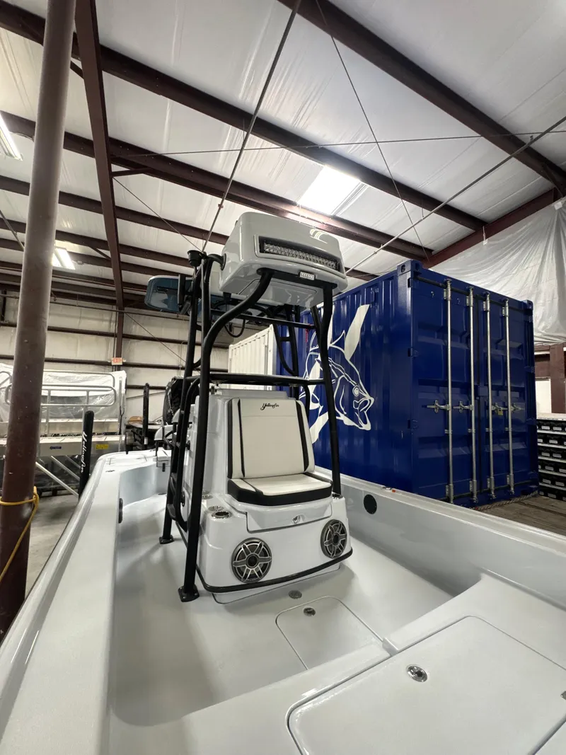 Slide: The Image of 2025 Yellowfin 24 CE boat in a warehouse, featuring advanced navigation equipment. - 6