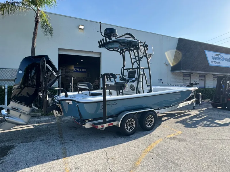 Slide: The Image of 2025 Yellowfin 24 CE boat on trailer outside Yamaha dealership. - 8