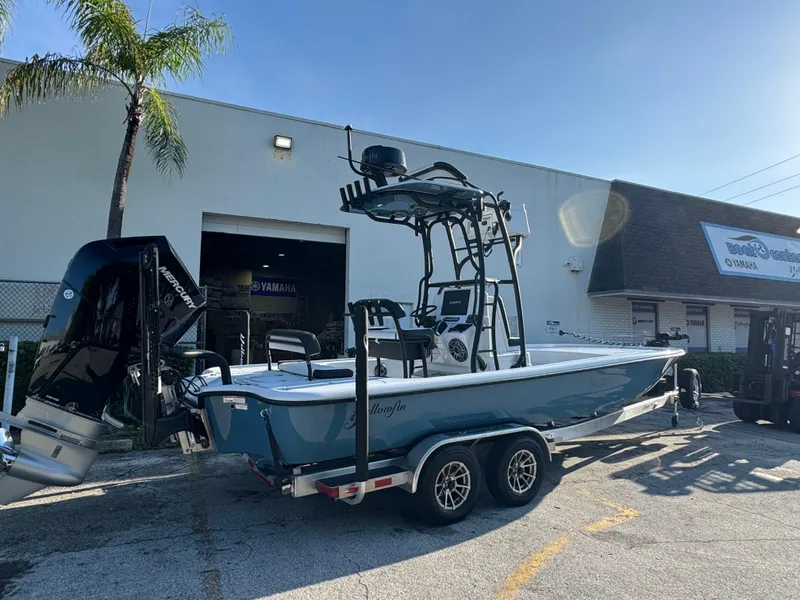 Slide: The Image of 2025 Yellowfin 24 CE boat on trailer outside dealership, featuring Mercury engine. - 9