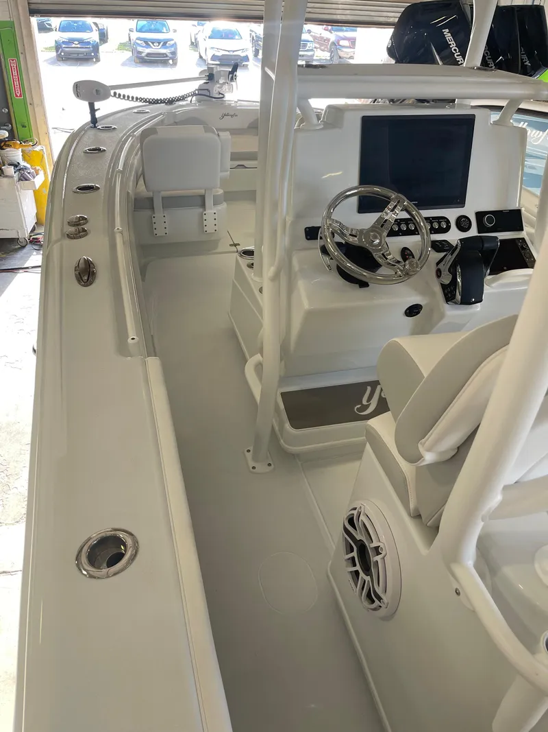 Slide: The Image of 2026 Yellowfin 26 Hybrid boat interior with white cushioned seating and sleek design. - 10