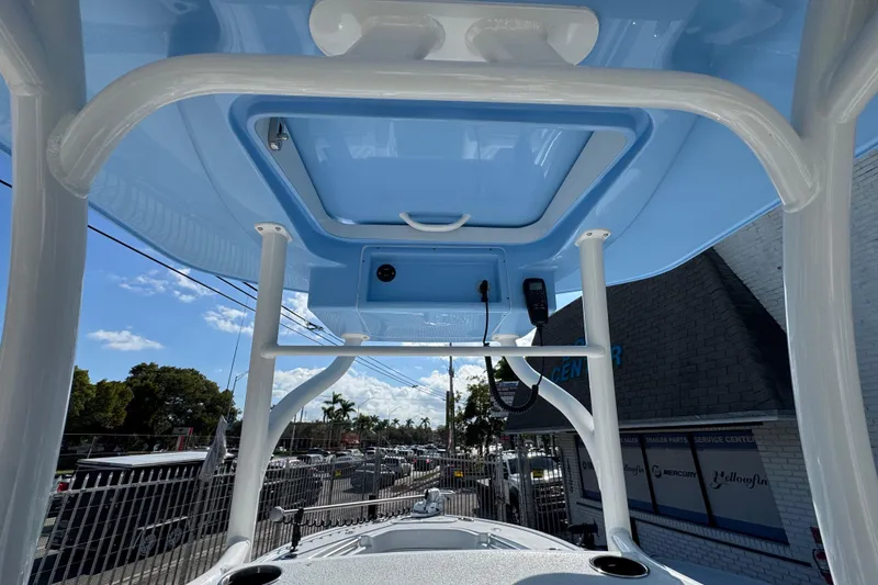 Slide: The Image of 2026 Yellowfin 26 Hybrid boat's T-top view with clear sky background. - 16