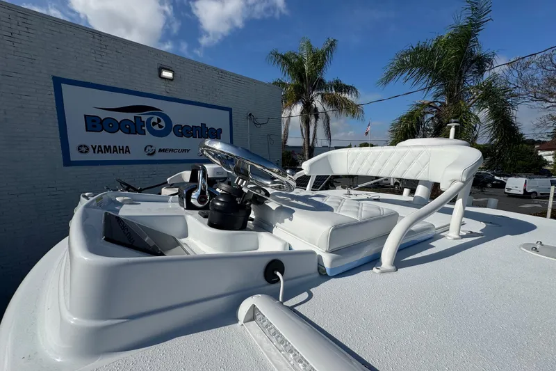 Slide: The Image of 2026 Yellowfin 26 Hybrid boat at dealership with palm trees and blue sky. - 17
