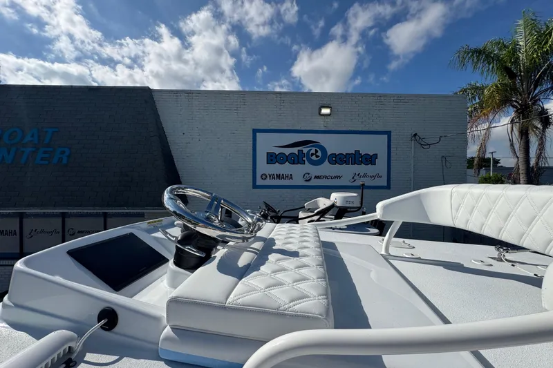 Slide: The Image of 2026 Yellowfin 26 Hybrid boat at dealership with clear sky background. - 18