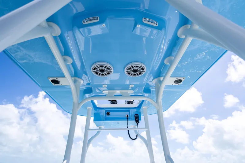 Slide: The Image of 2026 Yellowfin 26 Hybrid boat, blue T-top, speakers, clear sky background. - 22