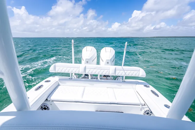 Slide: The Image of 2026 Yellowfin 26 Hybrid boat on turquoise ocean under blue sky. - 24