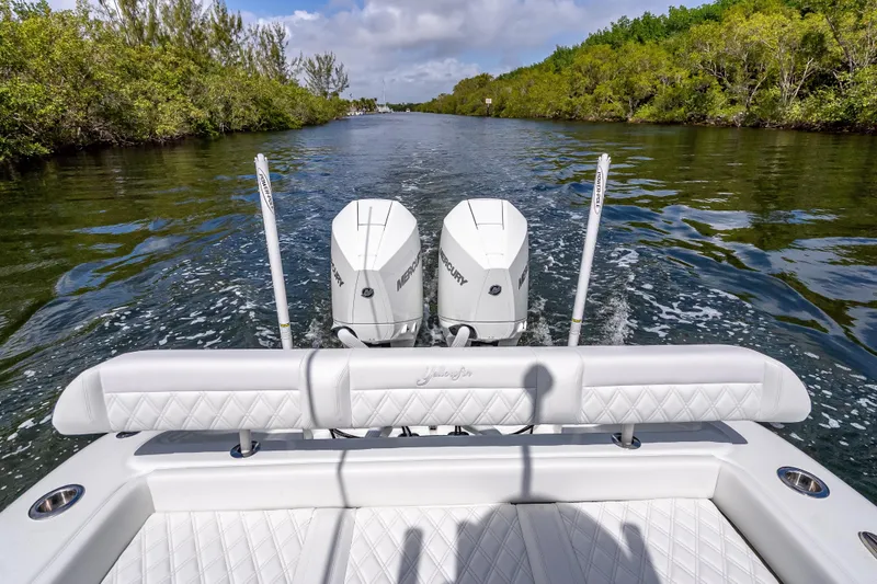 Slide: The Image of 2026 Yellowfin 26 Hybrid boat cruising through a scenic waterway with twin Mercury engines. - 27
