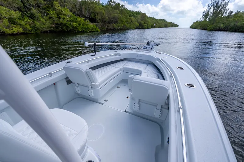 Slide: The Image of 2026 Yellowfin 26 Hybrid boat on a serene waterway, surrounded by lush greenery. - 32