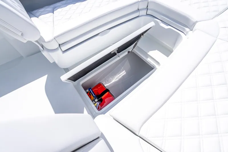 Slide: The Image of 2026 Yellowfin 26 Hybrid boat with open storage compartment and white cushioned seating. - 33