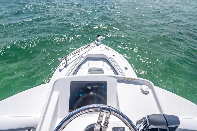 Slide: The Image of 2026 Yellowfin 26 Hybrid boat dashboard overlooking calm green waters. - 35