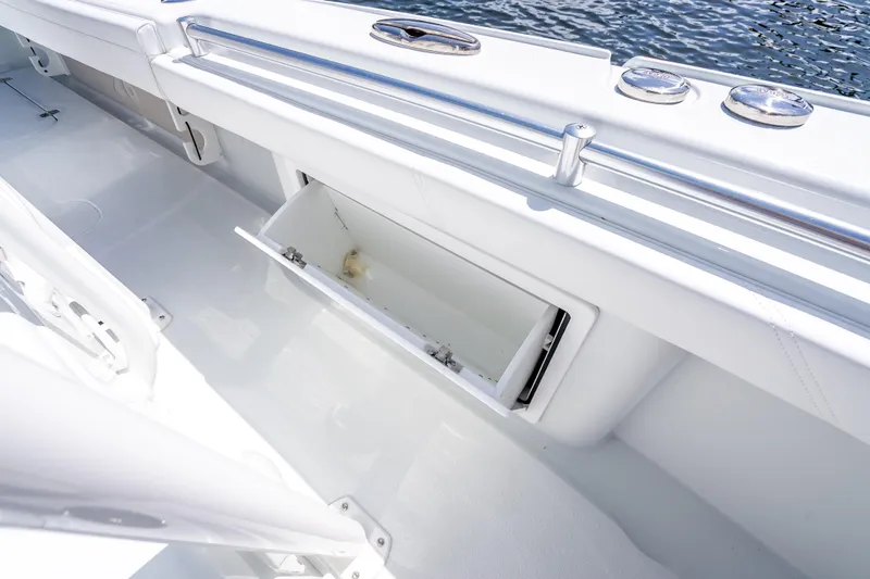 Slide: The Image of 2026 Yellowfin 26 Hybrid boat interior with open storage compartment, sleek white design. - 36
