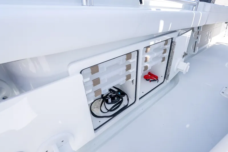 Slide: The Image of 2026 Yellowfin 26 Hybrid boat storage compartments with cables and accessories. - 37