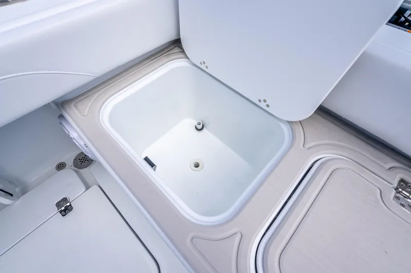 Slide: The Image of Open storage compartment on 2026 Yellowfin 26 Hybrid boat, showcasing interior design. - 40