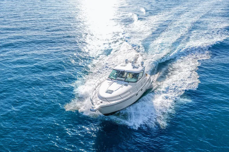 Slide: The Image of 2008 Tiara Yachts 4300 Sovran cruising on open blue water. - 10