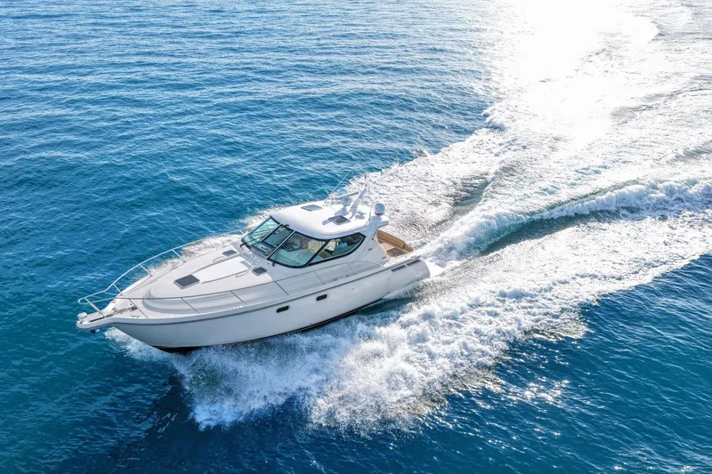 Slide: The Image of 2008 Tiara Yachts 4300 Sovran cruising on open blue water. - 11