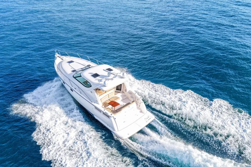 Slide: The Image of 2008 Tiara Yachts 4300 Sovran cruising on open blue water. - 12