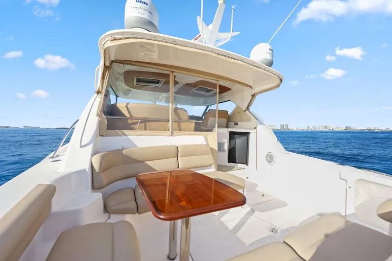 Slide: The Image of 2008 Tiara Yachts 4300 Sovran with spacious deck and seating, cruising on open water. - 20