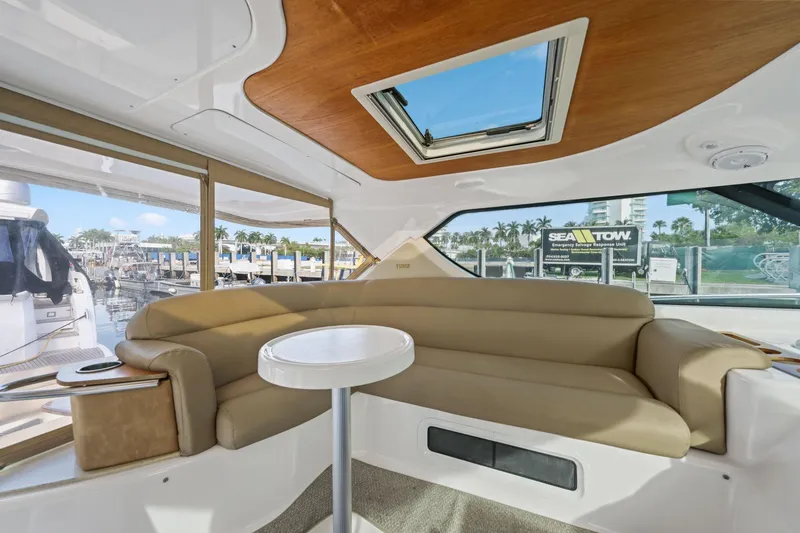Slide: The Image of Interior of 2008 Tiara Yachts 4300 Sovran with beige seating and marina view. - 23